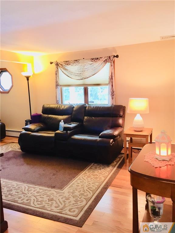 387 Middle Road Hazlet, NJ 07730 - Photo 5 of 20 a living room with furniture and a lamp