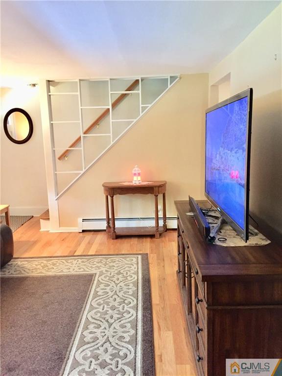 387 Middle Road Hazlet, NJ 07730 - Photo 6 of 20 a hallway with a couch and a bookshelf