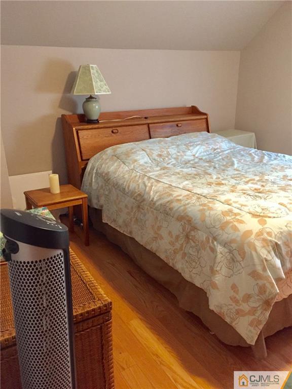 387 Middle Road Hazlet, NJ 07730 - Photo 10 of 20 a bedroom with a bed and lamp