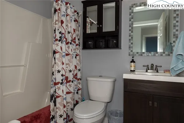 a bathroom with a toilet a sink and a mirror