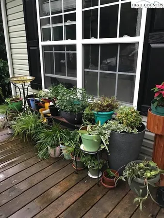 a view of a chair and table in back yard of a house