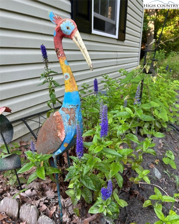 111 Peace Hill Road Fleetwood, NC 28626 - Photo 33 of 49 a view of a house with a flower garden