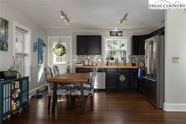 a kitchen with a table chairs and a refrigerator