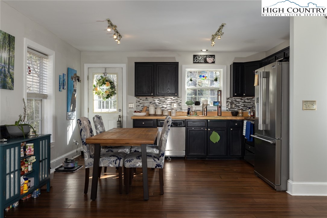 111 Peace Hill Road Fleetwood, NC 28626 - Photo 6 of 49 a kitchen with a table chairs and a refrigerator