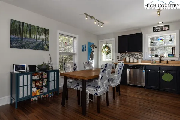 a view of a dining room with furniture and wooden floor