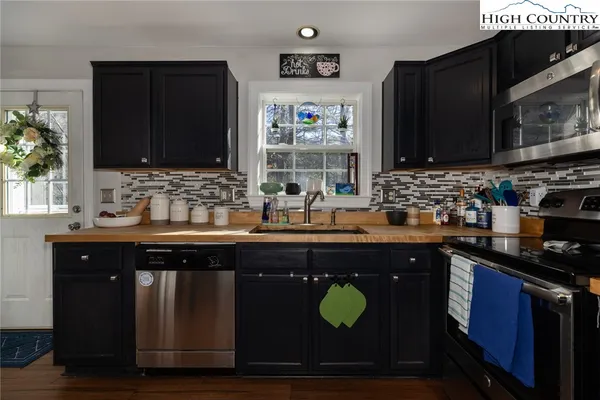 a kitchen with a sink stove and microwave