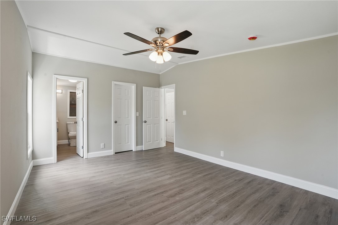 897 Manatee Road Naples, FL 34114 - Photo 17 of 36 a view of an empty room with a ceiling fan