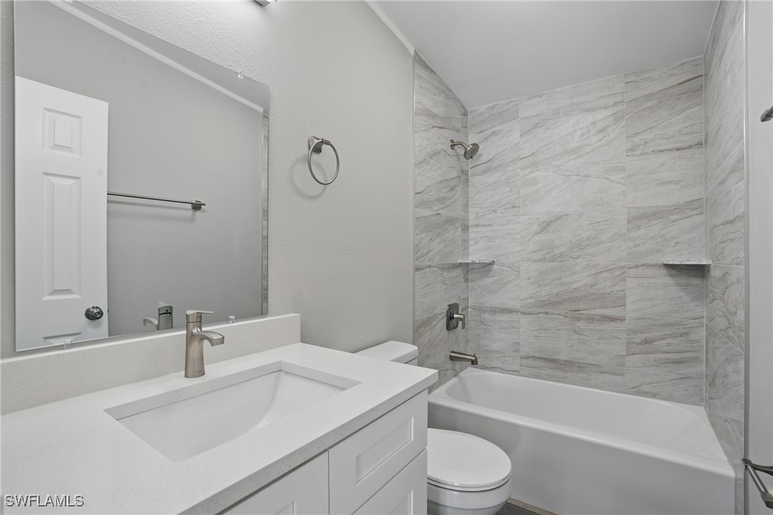 897 Manatee Road Naples, FL 34114 - Photo 21 of 36 a bathroom with a sink toilet vanity and shower
