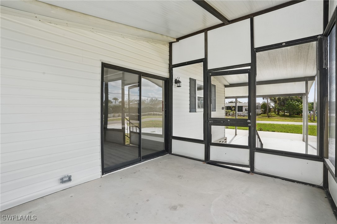 897 Manatee Road Naples, FL 34114 - Photo 23 of 36 a view of an empty room with large windows