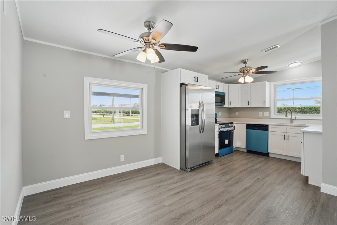 897 Manatee Road Naples, FL 34114 - Photo 7 of 36 a kitchen with stainless steel appliances a refrigerator and a stove top oven