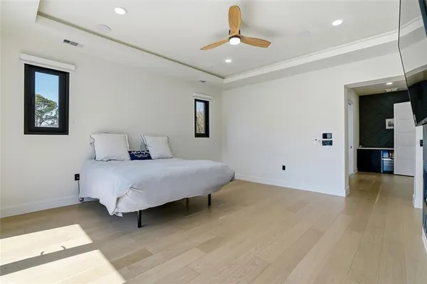 a view of a hallway with wooden floor and cabinet