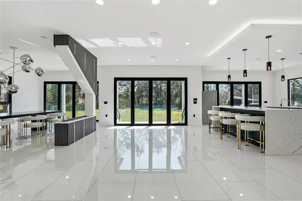 a living room with stainless steel appliances kitchen island furniture and a window