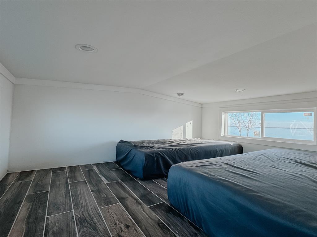 6422 Peninsula Road Kerens, TX 75144 - Photo 10 of 16 a bedroom with a bed and wooden floor