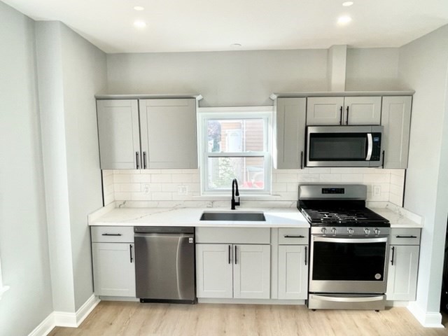 a kitchen with white cabinets and white appliances