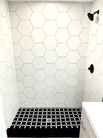 a bathroom with a black white checkered floor