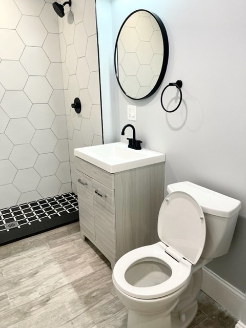 38 Oneida Street, Unit 2 Lynn, MA 01902 - Photo 15 of 22 a bathroom with a toilet a sink and a mirror