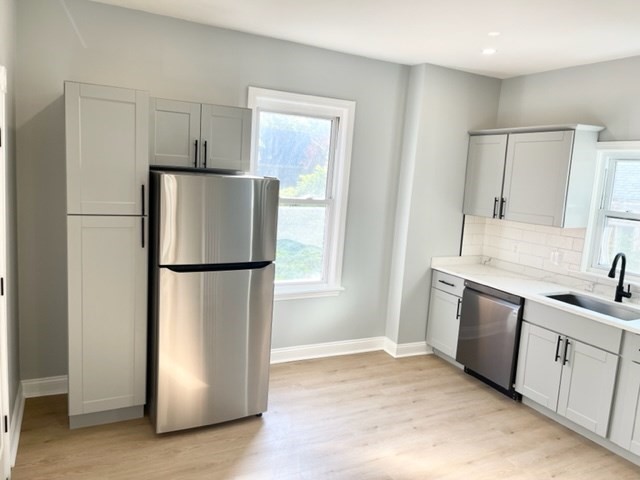 38 Oneida Street, Unit 2 Lynn, MA 01902 - Photo 2 of 22 a kitchen with stainless steel appliances a refrigerator and a sink