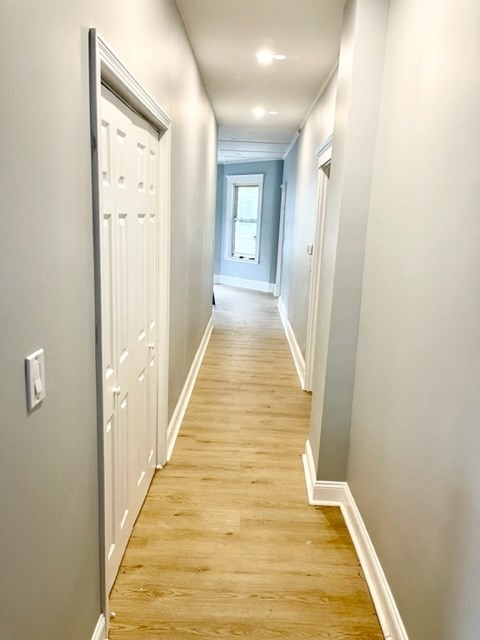 38 Oneida Street, Unit 2 Lynn, MA 01902 - Photo 9 of 22 a view of a hallway with wooden floor and staircase