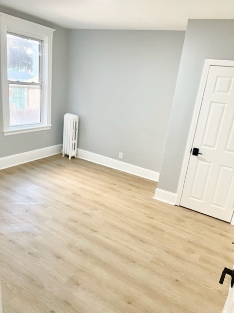 38 Oneida Street, Unit 2 Lynn, MA 01902 - Photo 10 of 22 an empty room with wooden floor and window