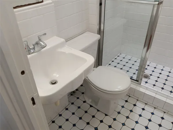 a white toilet sitting next to a bathroom sink