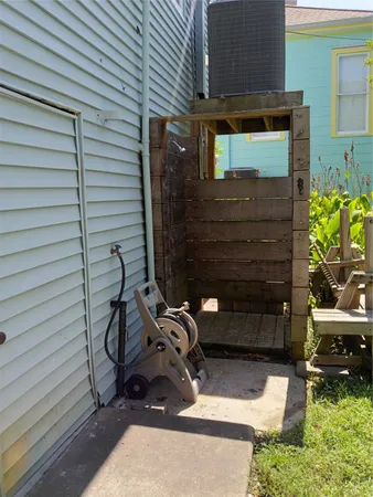 a side view of a house with a tree