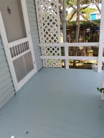 a view of a porch with wooden floor and fence