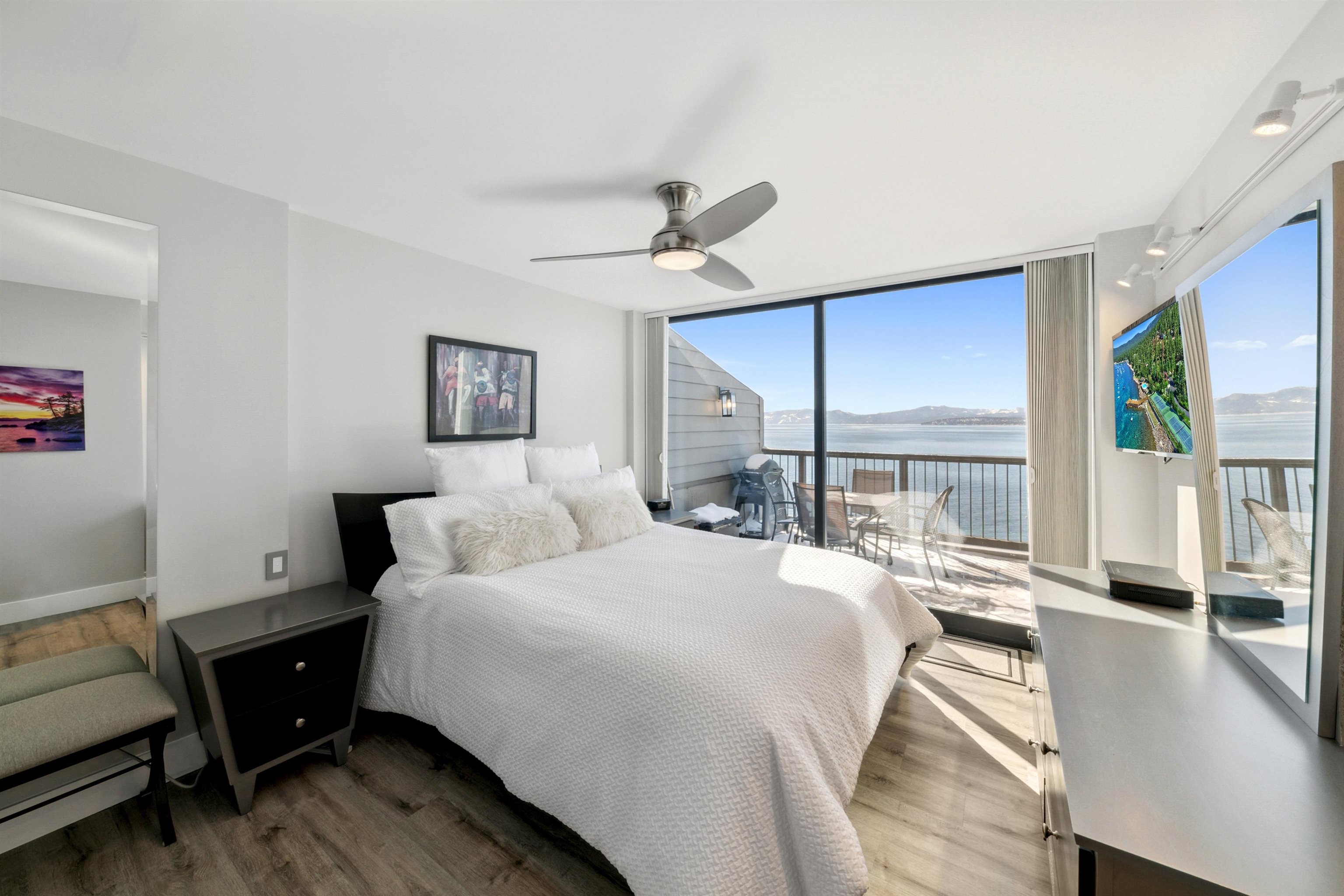 9200 Brockway Springs Drive, Unit 72 Kings Beach, CA 96143 - Photo 11 of 21 a bedroom with a bed a table and large windows