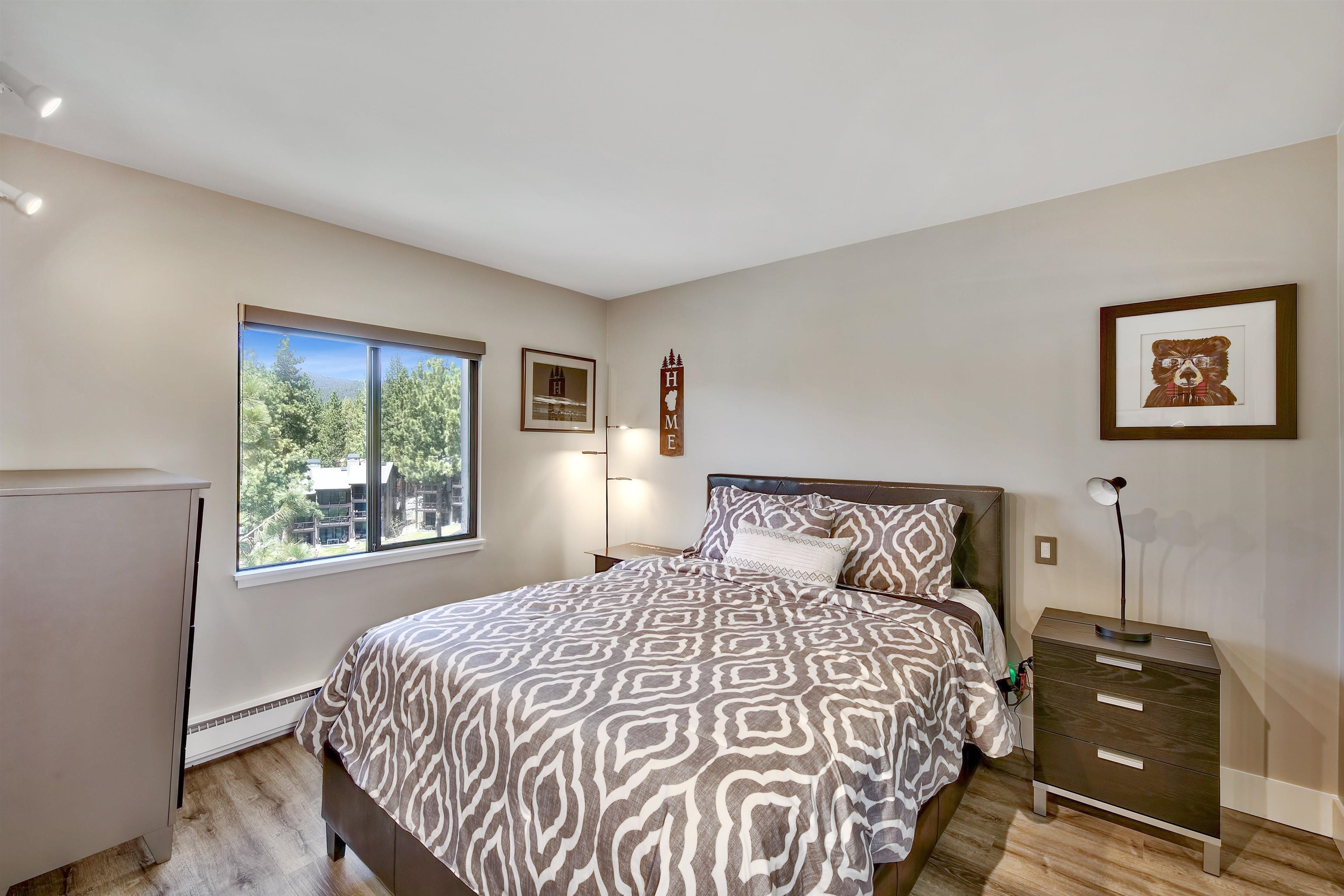 9200 Brockway Springs Drive, Unit 72 Kings Beach, CA 96143 - Photo 13 of 21 a bedroom with a bed and wooden floor