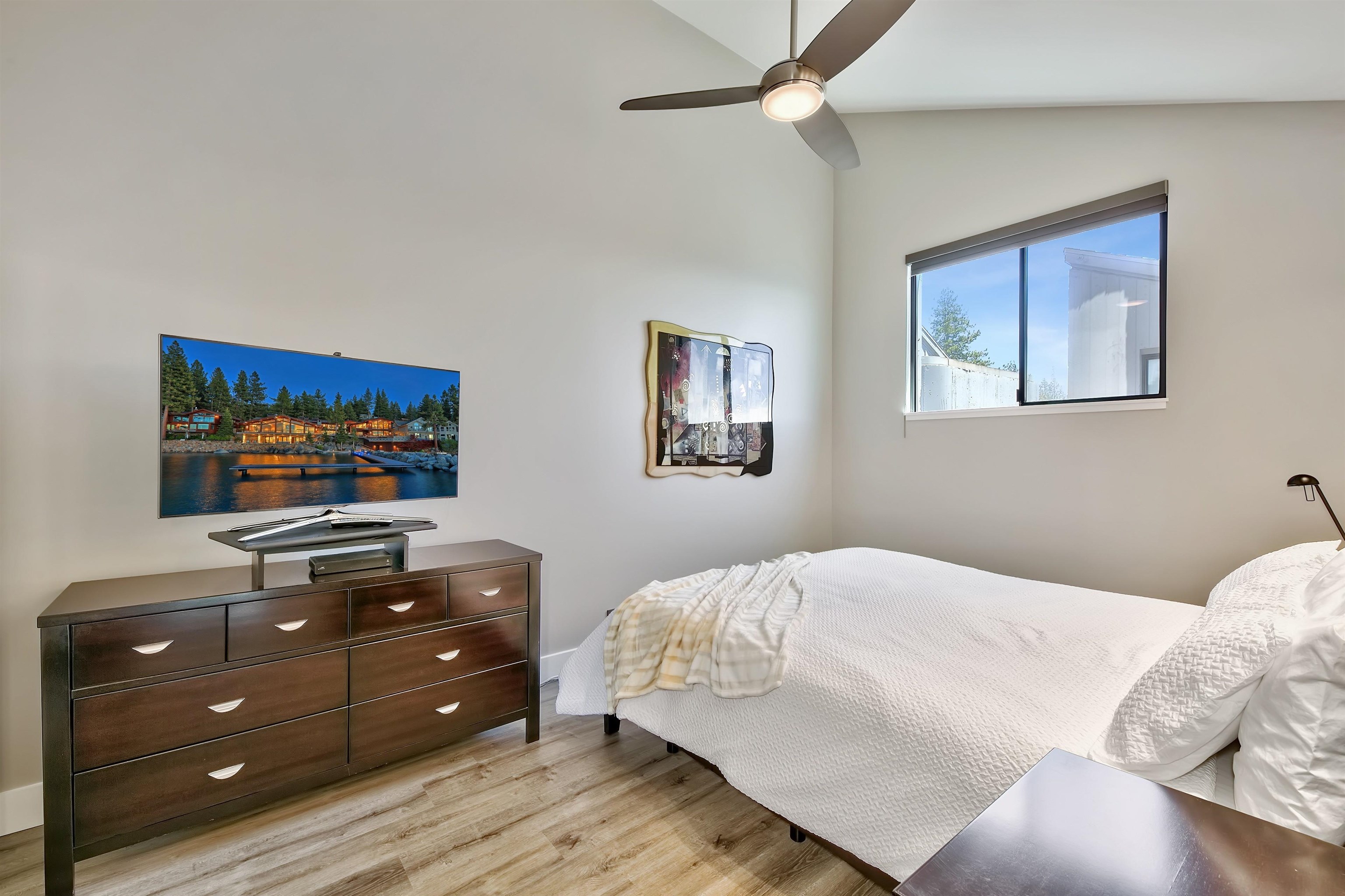 9200 Brockway Springs Drive, Unit 72 Kings Beach, CA 96143 - Photo 15 of 21 a bedroom with a bed and a flat screen tv