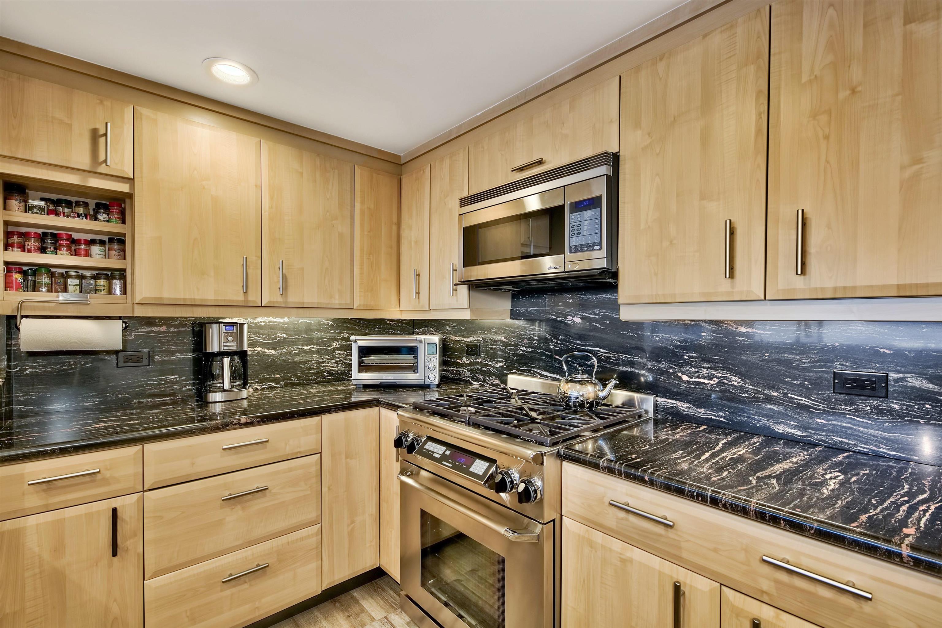 9200 Brockway Springs Drive, Unit 72 Kings Beach, CA 96143 - Photo 10 of 21 a kitchen with granite countertop a sink a stove and cabinets