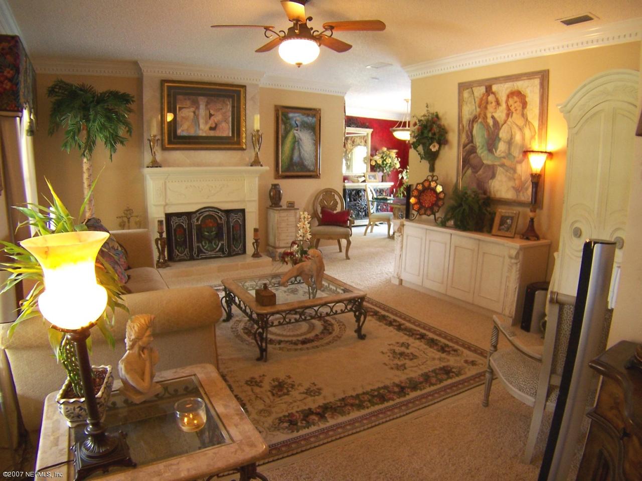 4247 Heath Road Jacksonville, FL 32277 - Photo 12 of 27 a living room with furniture and a fireplace