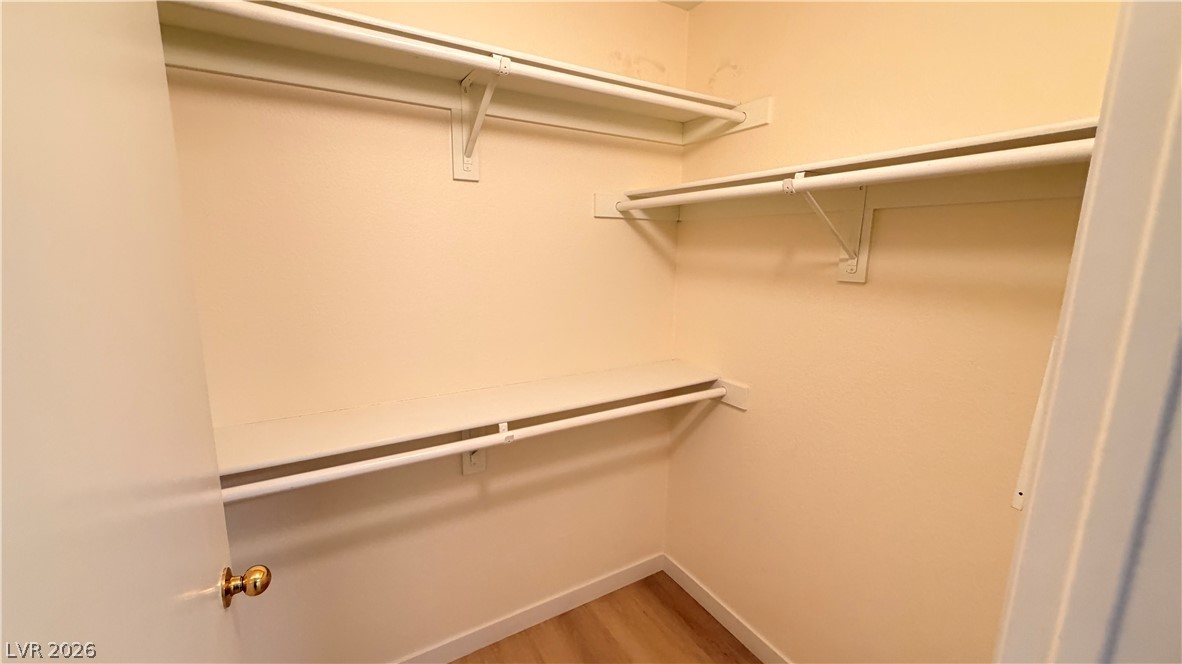 7885 West Flamingo Road, Unit 1131 Las Vegas, NV 89147 - Photo 25 of 36 This walk-in closet offers extensive shelving and hanging space for effortless organization.