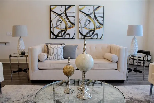 a living room with furniture and wooden floor