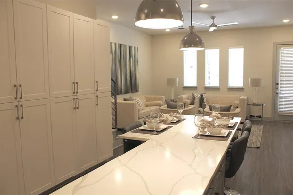 a large kitchen with kitchen island a stove a sink and a refrigerator