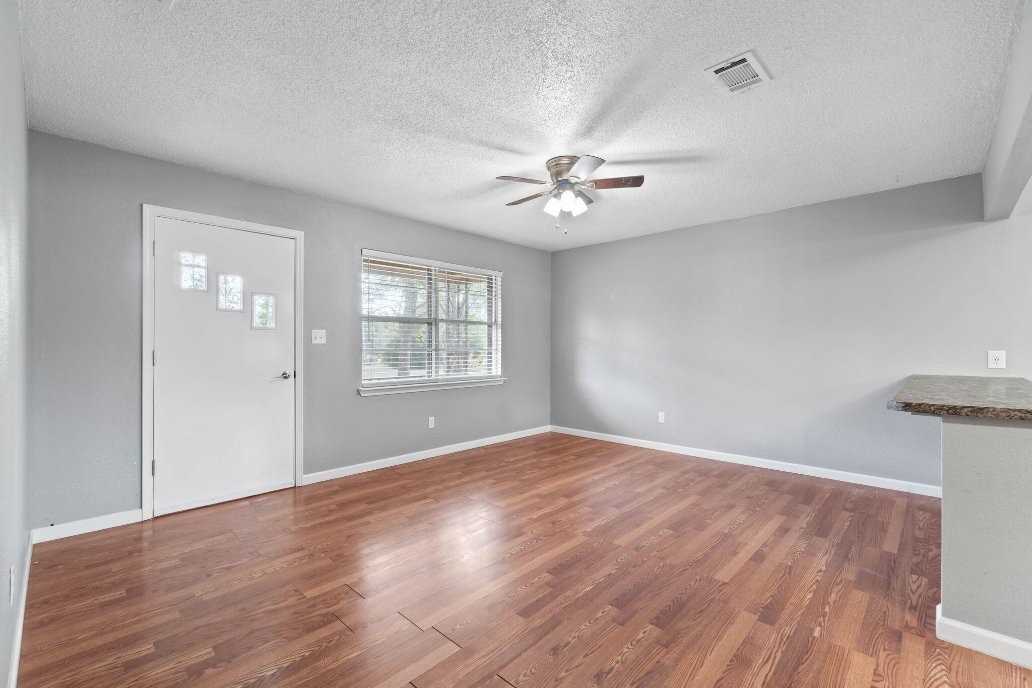 3545 Poverty Creek Road Crestview, FL 32539 - Photo 11 of 33 wooden floor in an empty room with a window