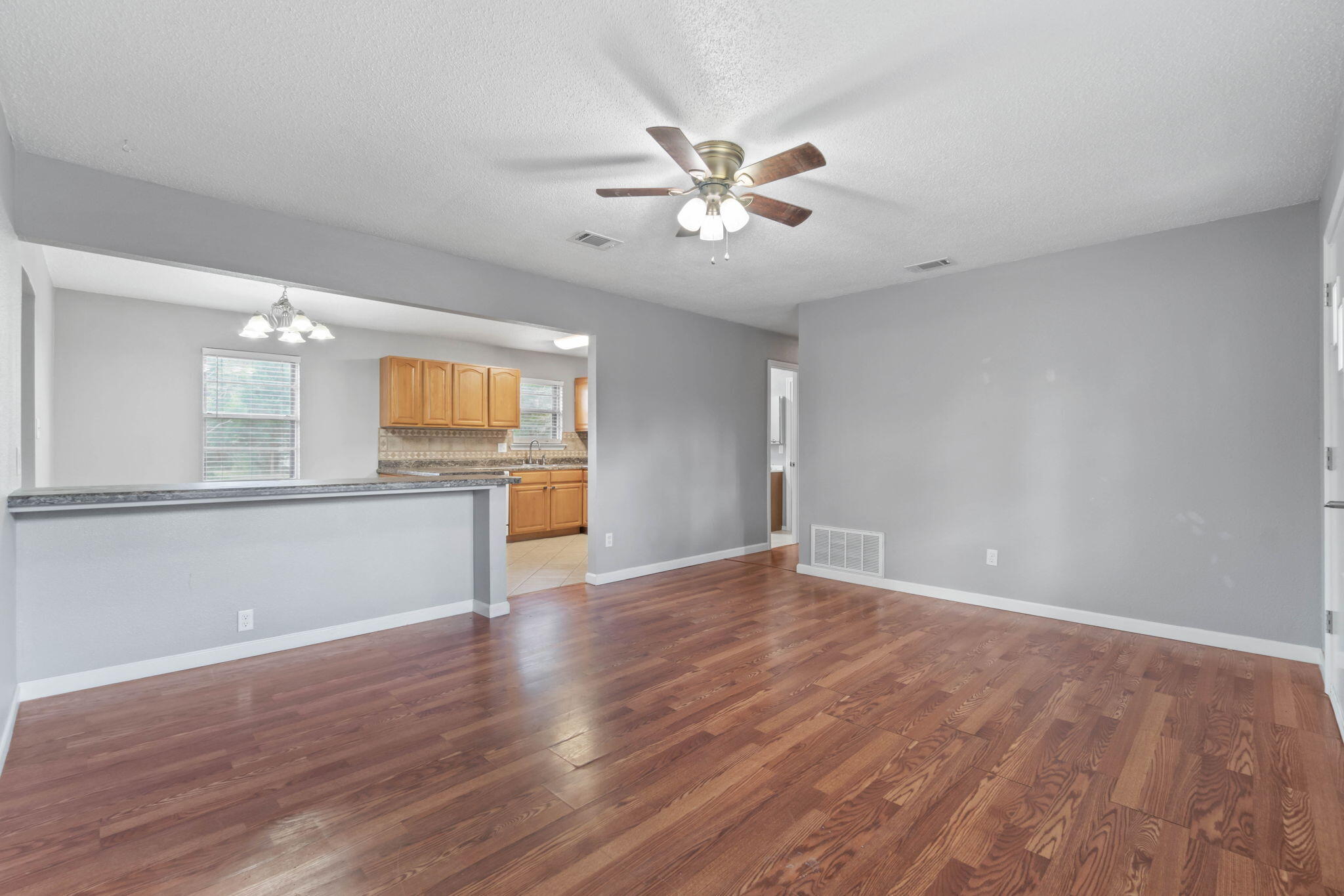 3545 Poverty Creek Road Crestview, FL 32539 - Photo 12 of 33 a view of an empty room with wooden floor and a window