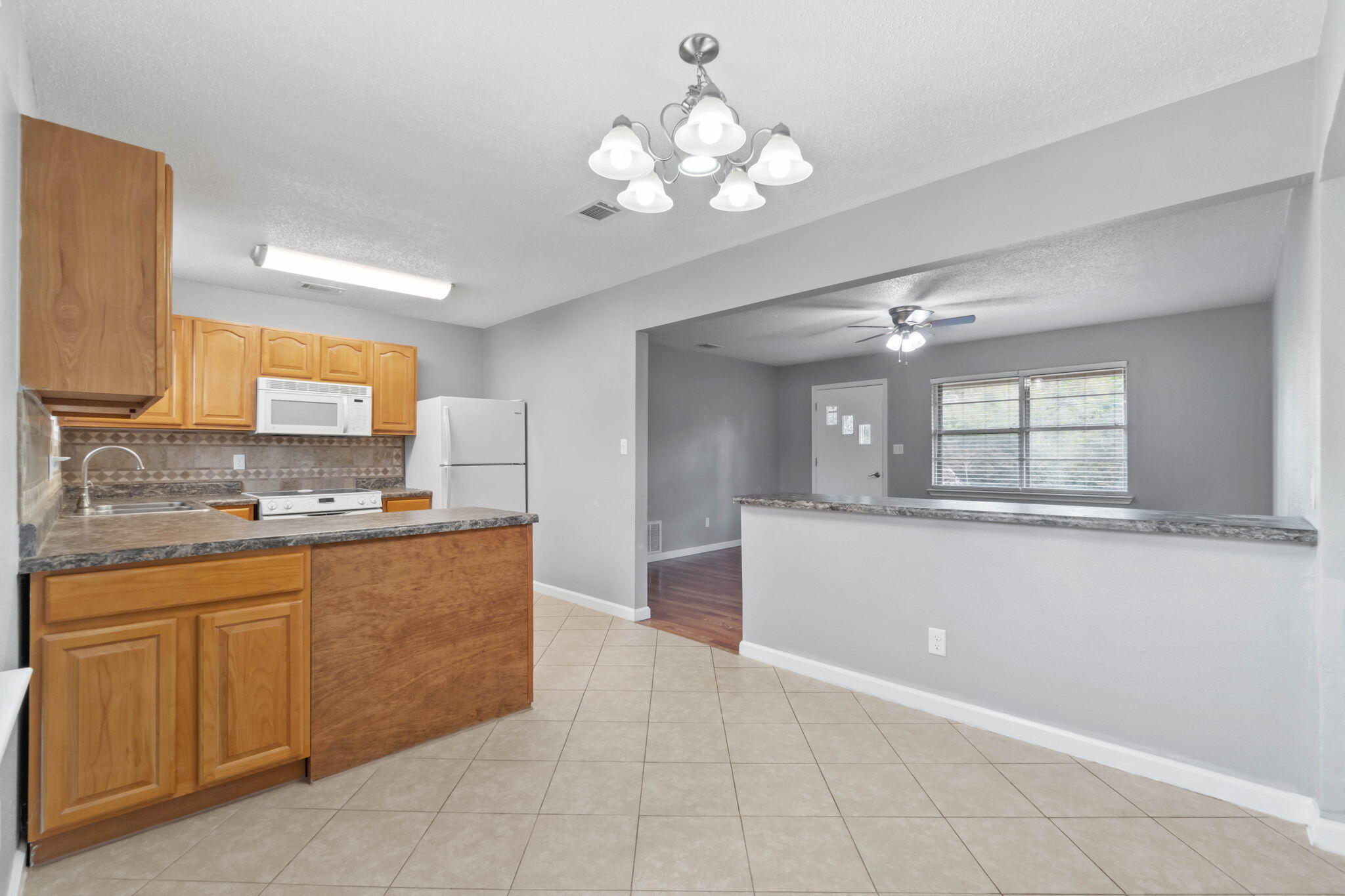 3545 Poverty Creek Road Crestview, FL 32539 - Photo 15 of 33 a large kitchen with kitchen island granite countertop a sink counter top space and cabinets