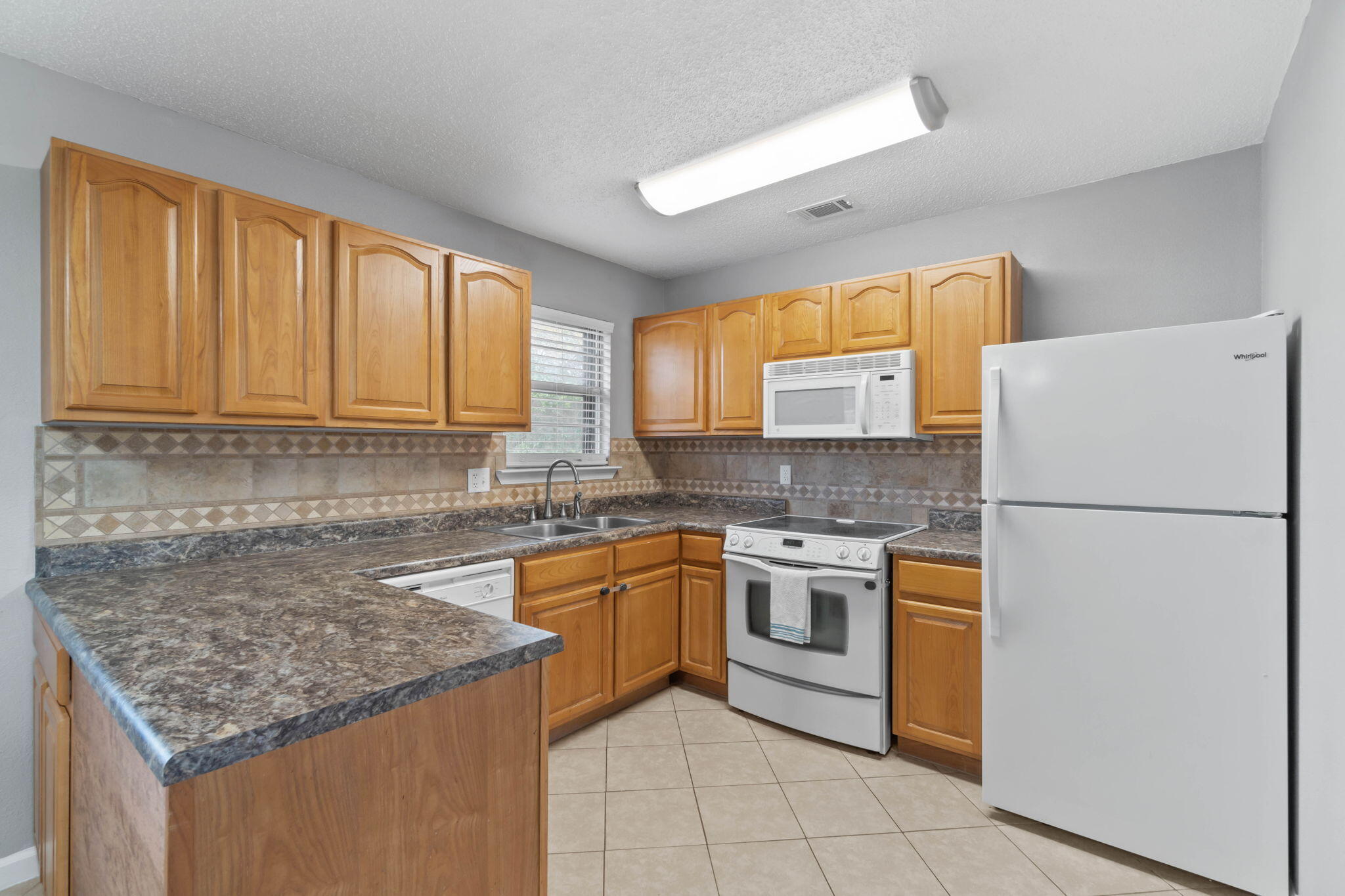 3545 Poverty Creek Road Crestview, FL 32539 - Photo 16 of 33 a kitchen with a sink stove and refrigerator