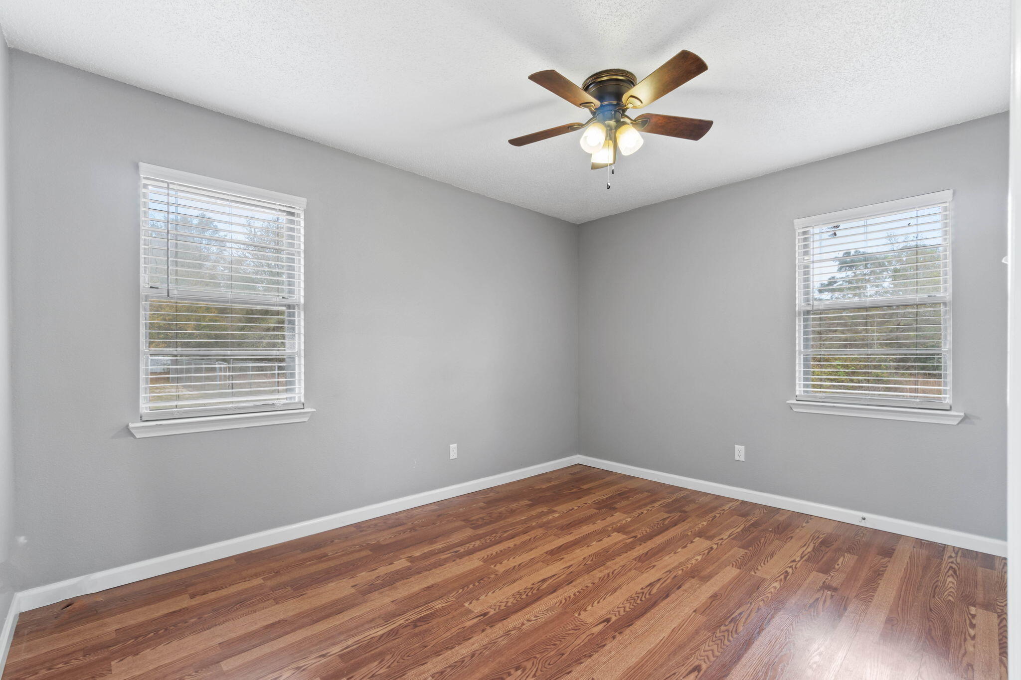 3545 Poverty Creek Road Crestview, FL 32539 - Photo 21 of 33 a view of an empty room with wooden floor and a window