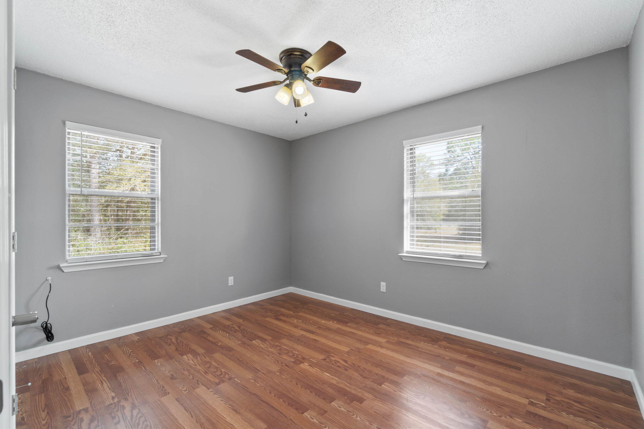 3545 Poverty Creek Road Crestview, FL 32539 - Photo 23 of 33 a view of empty room with wooden floor and fan