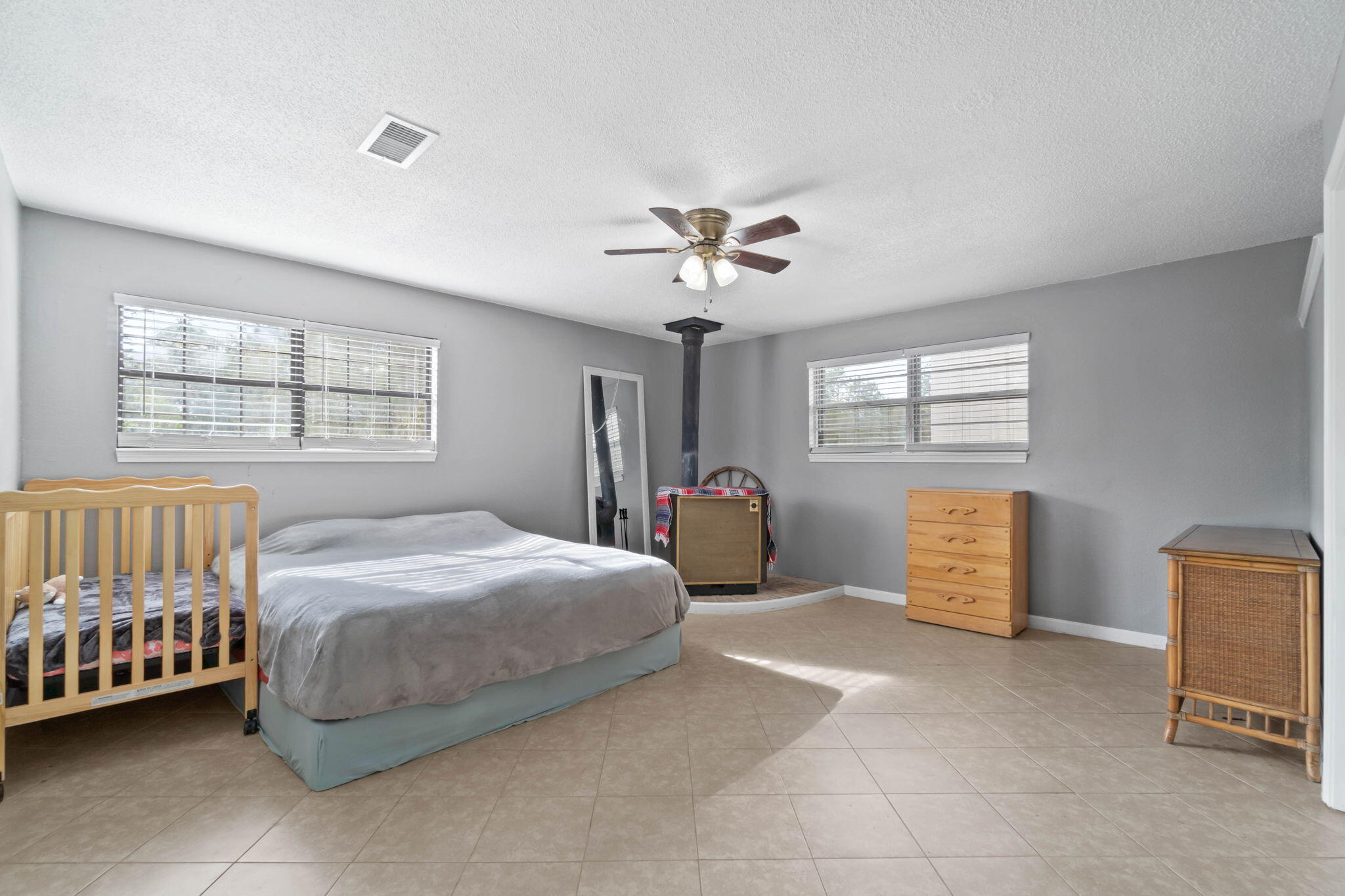 3545 Poverty Creek Road Crestview, FL 32539 - Photo 29 of 33 a bedroom with a bed and a chandelier