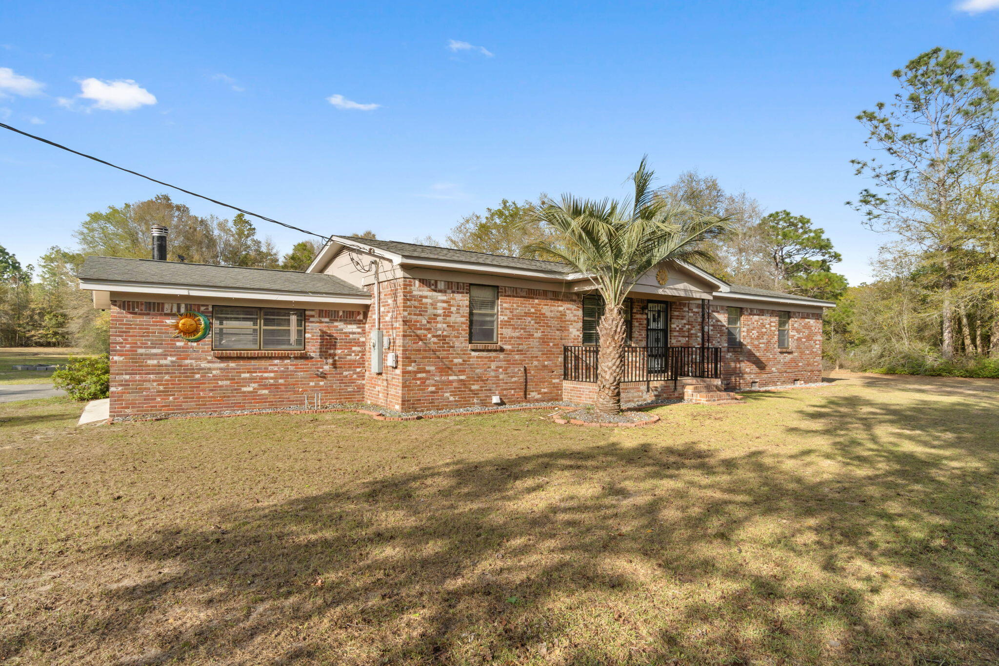 3545 Poverty Creek Road Crestview, FL 32539 - Photo 3 of 33 a front view of a house with garden