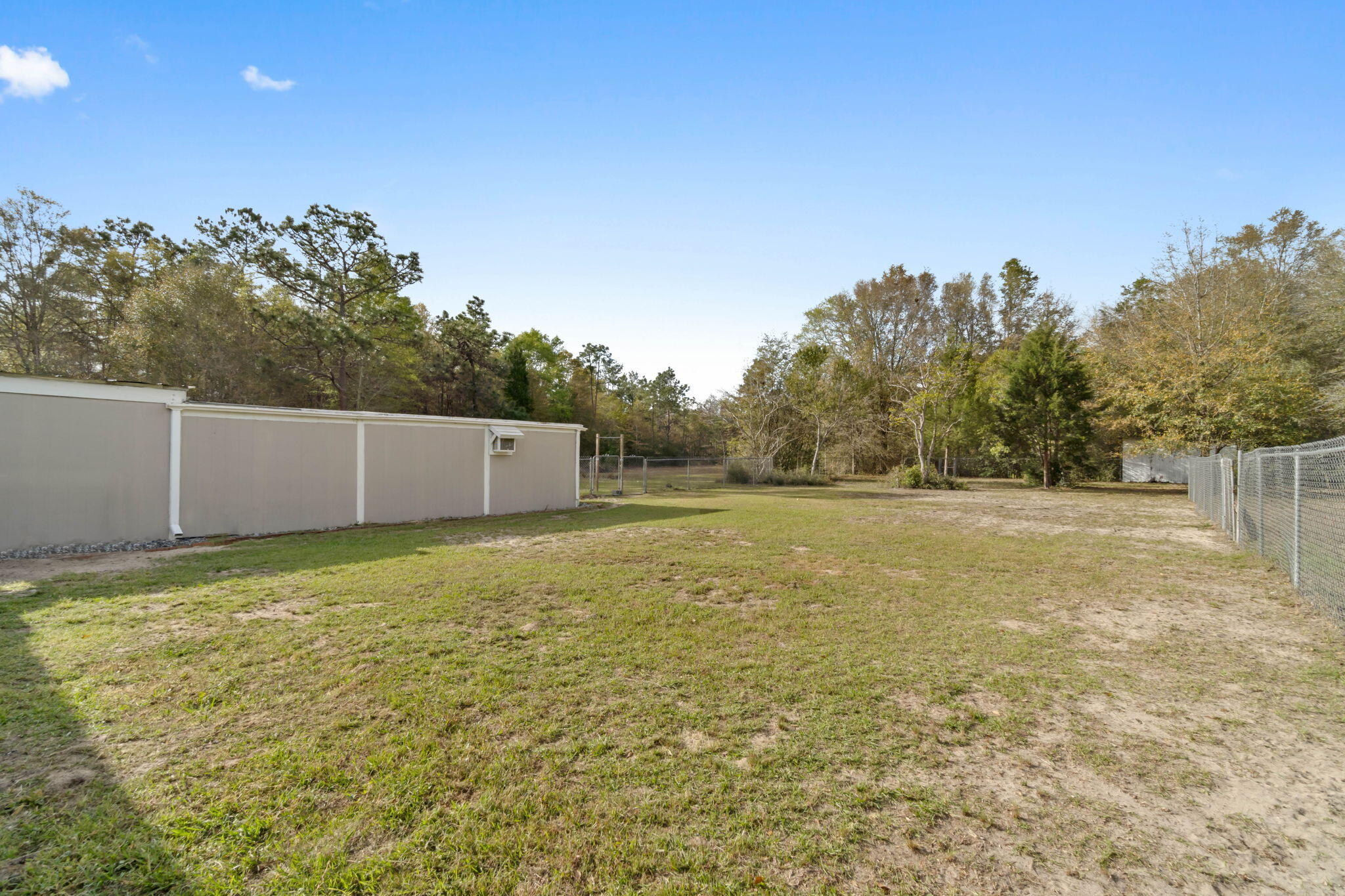 3545 Poverty Creek Road Crestview, FL 32539 - Photo 33 of 33 a backyard of a house with lots of green space