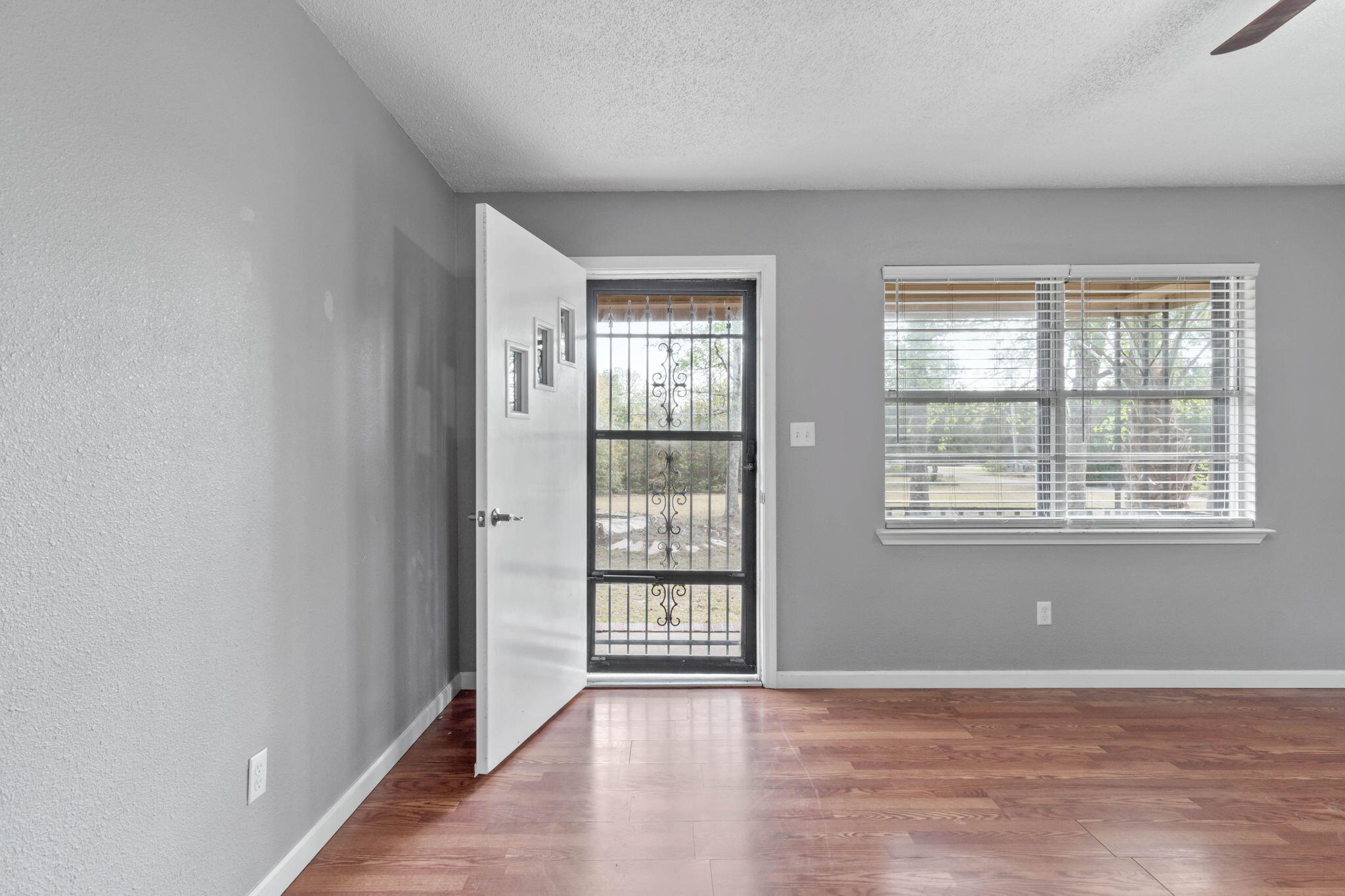 3545 Poverty Creek Road Crestview, FL 32539 - Photo 9 of 33 a view of an empty room with wooden floor and windows