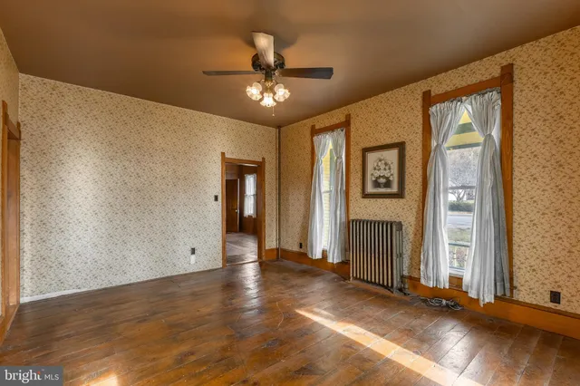 a view of a kitchen with kitchen island a sink stainless steel appliances and cabinets