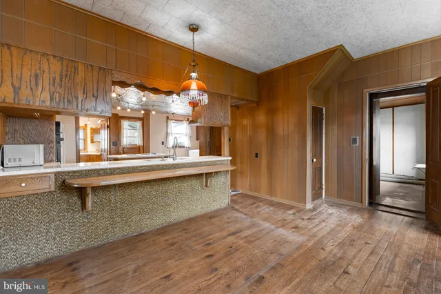 a sink with granite countertop a mirror and bathtub