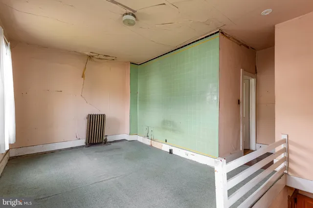 a view of empty room with wooden ceiling