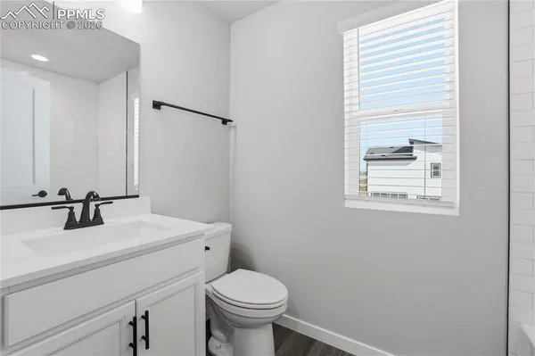 a bathroom with a sink toilet and vanity