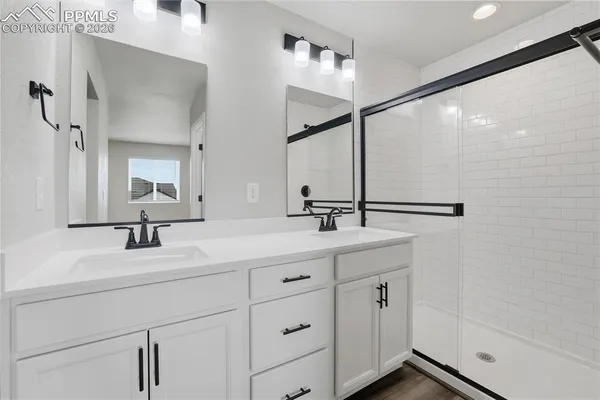 a bathroom with a double vanity sink and mirror
