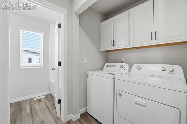 a view of storage and utility room with washer and dryer
